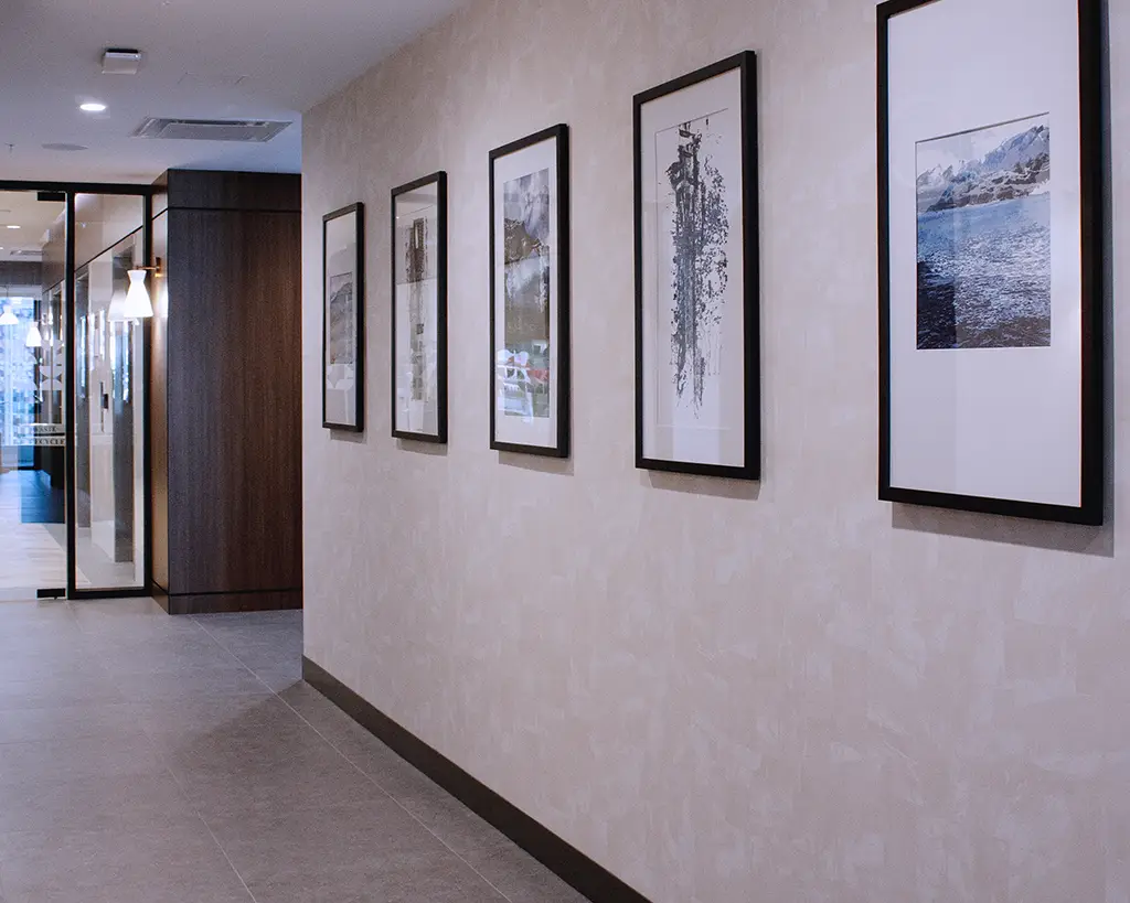 Row of 5 framed artworks in public area of hotel